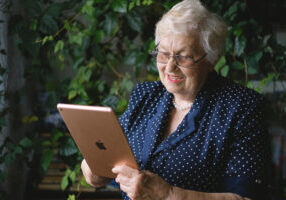 Happy elderly woman using an iPad